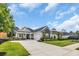 Well-manicured lawn and landscaping enhance this home with stone accents and an attached garage at 1024 Pochard Dr., Conway, SC 29526