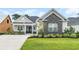 Charming single-story home featuring stone accents, manicured lawn, and a welcoming front porch at 1024 Pochard Dr., Conway, SC 29526