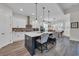 Stylish kitchen featuring a large island, white cabinets, stainless steel appliances, and modern lighting at 1024 Pochard Dr., Conway, SC 29526