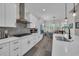 Bright kitchen showcasing white cabinets, modern appliances, a stylish backsplash, and open dining area at 1024 Pochard Dr., Conway, SC 29526