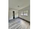 Bright bedroom with wood-look flooring, closet, and a window providing natural light and ventilation at 1025 Carolina Rd. # H4, Conway, SC 29526