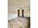 A bright bedroom with wood-look floors, closets, and natural light from the window at 1025 Carolina Rd. # H4, Conway, SC 29526