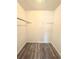 A simple closet with wood-look flooring, rod, and ample space for clothing and storage needs at 1025 Carolina Rd. # H4, Conway, SC 29526