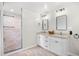 Well-lit bathroom with a double vanity, modern fixtures, and a stylish glass shower at 103 Wofford Ln., Conway, SC 29526