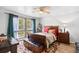 Charming bedroom with a wooden bed frame, colorful rug, and a ceiling fan at 103 Wofford Ln., Conway, SC 29526