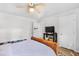 Bright bedroom featuring a ceiling fan, white walls, and a television on a wooden stand at 103 Wofford Ln., Conway, SC 29526