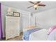Comfortable bedroom boasts a rattan dresser, a closet and a ceiling fan at 103 Wofford Ln., Conway, SC 29526