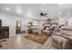 Bright living room with a brick fireplace, patterned rug and wood flooring at 103 Wofford Ln., Conway, SC 29526