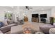 Open-concept living room with a comfortable sectional sofa, ceiling fan, and hardwood floors at 103 Wofford Ln., Conway, SC 29526