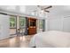 Bright main bedroom with a ceiling fan, hardwood floors, and several large windows at 103 Wofford Ln., Conway, SC 29526