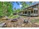 View of backyard featuring brick patio with fire pit, surrounded by a lush landscape at 1072 Chelsey Circle, Conway, SC 29526