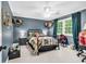 Charming bedroom with a ceiling fan, comfortable bed, and blue walls at 1072 Chelsey Circle, Conway, SC 29526