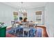Bright dining room featuring hardwood floors, modern lighting, and ample seating for Gathering and guests at 1072 Chelsey Circle, Conway, SC 29526
