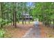 Exterior view of a two-story home with inviting porch, surrounded by trees and a private driveway at 1072 Chelsey Circle, Conway, SC 29526