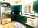 Modern kitchen with stainless steel refrigerator, green cabinets, and a window offering natural light at 1072 Chelsey Circle, Conway, SC 29526