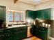 Stylish kitchen with dark green cabinetry, stainless steel appliances, and a cozy window view at 1072 Chelsey Circle, Conway, SC 29526