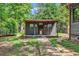 Exterior of an outbuilding with a brick walkway and wooded surroundings at 1072 Chelsey Circle, Conway, SC 29526
