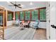 Cozy sunroom boasts a wall of windows, comfortable seating, and hardwood floors at 1072 Chelsey Circle, Conway, SC 29526