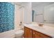 Bright bathroom featuring a shower/tub combo with stylish blue shower curtain and a white sink vanity with a mirror at 1120 Fairway Ln. # 1120, Conway, SC 29526