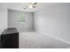 Bedroom featuring gray carpeting, neutral gray walls, a window, and a ceiling fan at 1120 Fairway Ln. # 1120, Conway, SC 29526