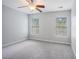 Bedroom with two windows, ceiling fan, gray walls, and plush gray carpeting at 1120 Fairway Ln. # 1120, Conway, SC 29526