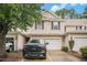 Charming two-story townhome with black shutters, a white garage door, and driveway with a black truck parked at 1120 Fairway Ln. # 1120, Conway, SC 29526
