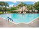 Community pool featuring clear blue water surrounded by lounge chairs, umbrellas, and palm trees at 1120 Fairway Ln. # 1120, Conway, SC 29526