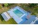 Aerial shot of the community pool with a fenced-in area, lounging chairs, and nearby shade structures at 1145 Forest Dr., North Myrtle Beach, SC 29582