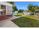 Landscaped backyard with storage sheds, patio, and a pathway leading to the home's sunroom at 1145 Forest Dr., North Myrtle Beach, SC 29582