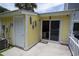 This is the back porch area with a yellow wall and a sliding glass door entrance at 12 Century St. # 12, Myrtle Beach, SC 29577