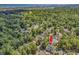 This aerial view showcases the home's location, surrounded by tree coverage, near the ocean at 1208 Trisail Ln, North Myrtle Beach, SC 29582