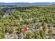 This aerial view highlights the home's location, surrounded by tree coverage, near the ocean at 1208 Trisail Ln, North Myrtle Beach, SC 29582