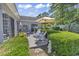 This backyard features green landscaping, patio furniture, and an umbrella-covered table at 1208 Trisail Ln, North Myrtle Beach, SC 29582