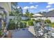 This backyard features an outdoor seating area, lush landscaping, and fencing for privacy at 1208 Trisail Ln, North Myrtle Beach, SC 29582