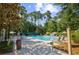 Inviting community pool area with lounge chairs, umbrellas, and lush greenery at 1208 Trisail Ln, North Myrtle Beach, SC 29582