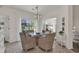 Dining room with large windows, stylish wicker chairs, and chandelier at 1208 Trisail Ln, North Myrtle Beach, SC 29582