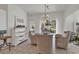 Bright dining area features glass table, wicker chairs, and chandelier at 1208 Trisail Ln, North Myrtle Beach, SC 29582