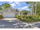 Charming single-story home featuring a manicured lawn and attached two-car garage at 1208 Trisail Ln, North Myrtle Beach, SC 29582