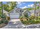 Charming single-story home featuring a manicured lawn and attached two-car garage at 1208 Trisail Ln, North Myrtle Beach, SC 29582
