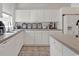 Bright kitchen featuring white cabinetry and durable tile flooring at 1208 Trisail Ln, North Myrtle Beach, SC 29582