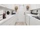 Efficient laundry room with ample storage and white appliances at 1208 Trisail Ln, North Myrtle Beach, SC 29582