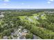 Aerial view overlooking neighborhood, golf course, and distant ocean at 1331 Bermuda Ct., Surfside Beach, SC 29575