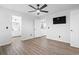 Bright bedroom features luxury vinyl plank flooring, a modern ceiling fan, and attached bathroom and kitchen access at 1331 Bermuda Ct., Surfside Beach, SC 29575