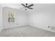 This well lit carpeted bedroom features a ceiling fan and a large window for plenty of natural light at 1331 Bermuda Ct., Surfside Beach, SC 29575
