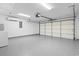 Garage featuring an epoxy floor, bright lighting, mini-split AC, and a white garage door at 1331 Bermuda Ct., Surfside Beach, SC 29575
