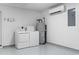 Garage space featuring a washer and dryer, water heater, mini-split AC, and a utility box at 1331 Bermuda Ct., Surfside Beach, SC 29575