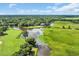 Stunning aerial view of the golf course community with lush greenery, waterways and elegant clubhouse at 139 Olde Canal Loop, Pawleys Island, SC 29585