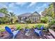 Well-manicured backyard featuring outdoor seating, lush landscaping, and a screened-in porch at 139 Olde Canal Loop, Pawleys Island, SC 29585