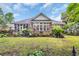 Beautiful brick home featuring a lush backyard and screened-in porch, perfect for outdoor living at 139 Olde Canal Loop, Pawleys Island, SC 29585