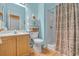 Clean bathroom with shower, toilet, shelving, and blue painted walls at 139 Olde Canal Loop, Pawleys Island, SC 29585